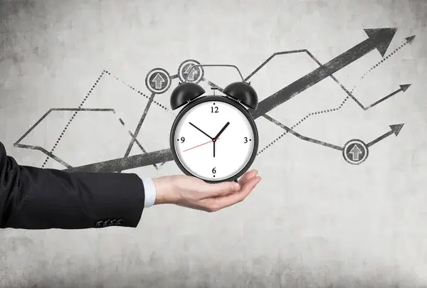 una mano sosteniendo un reloj que está señalando hacia arriba